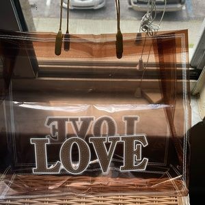 Brown see through small bag with love on both sides.